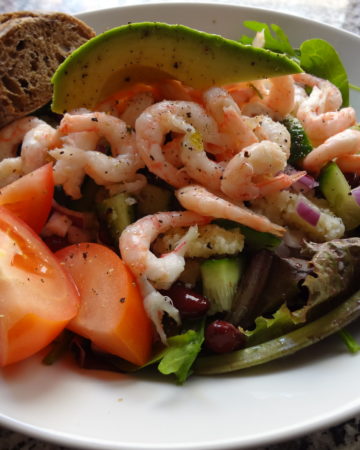 Beautiful salad of avocado, shrimp and vibrant greens