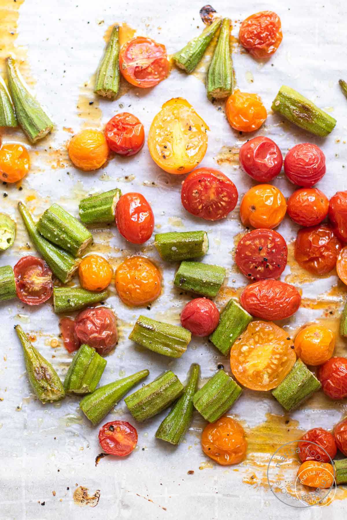 Cooked okra and tomatoes on parchment.