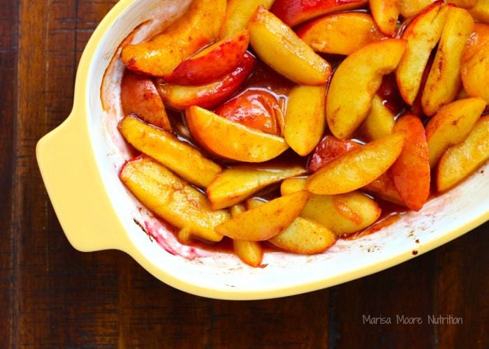 Saucy Roasted Peaches in a yellow casserole dish