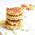 Stack of 4 crab cakes on a white plate