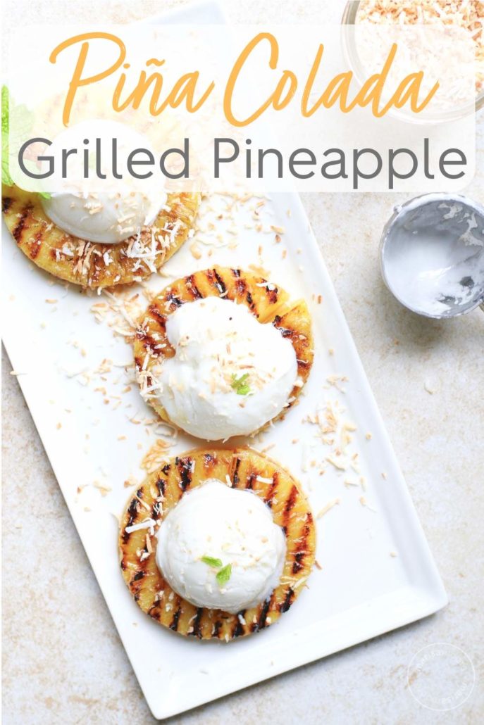 Grilled pineapple topped with coconut ice cream and toasted coconut on a plate