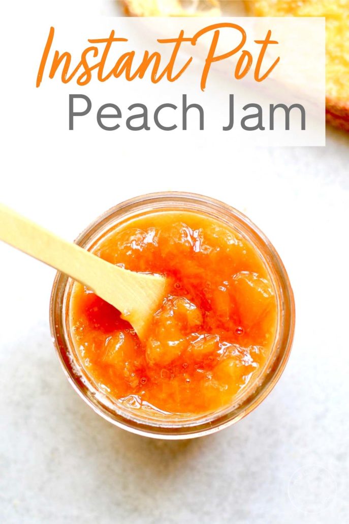 Peach Jam in a jar with a small wooden spoon dipper
