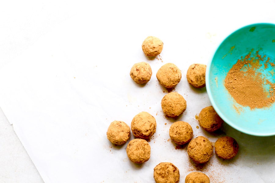 chocolate almond truffles tossed in cocoa in blue bowl