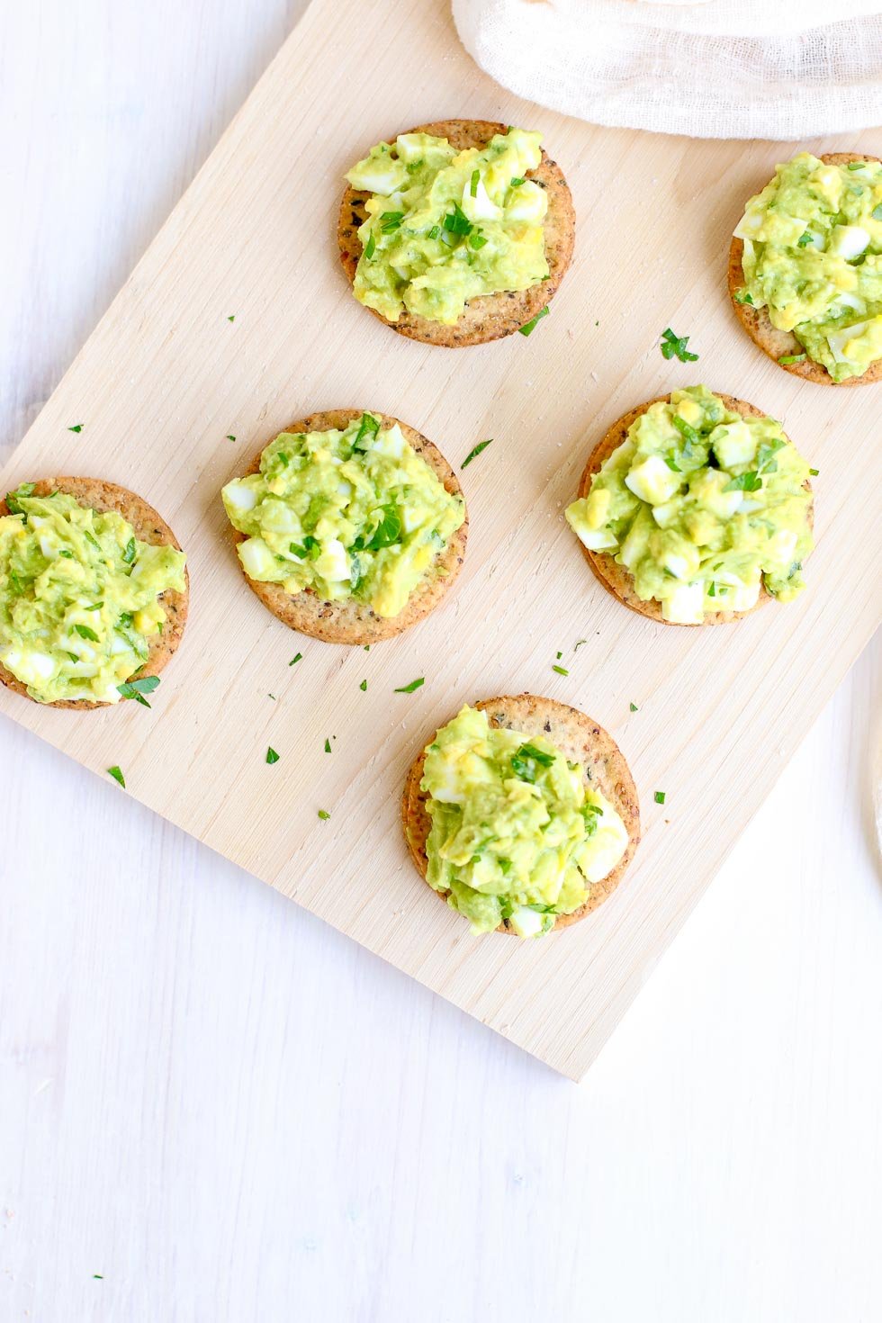 Avocado Egg Salad on Sprouted Seed Crackers overhead vertical