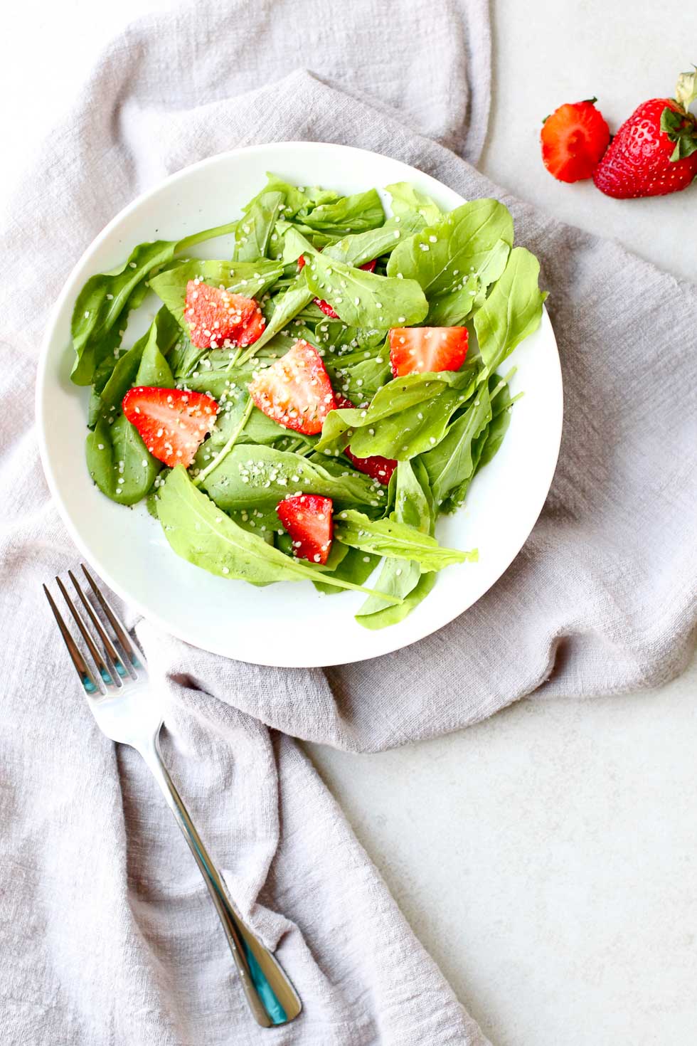 Strawberry Arugula Salad with Hemp Seed with fork