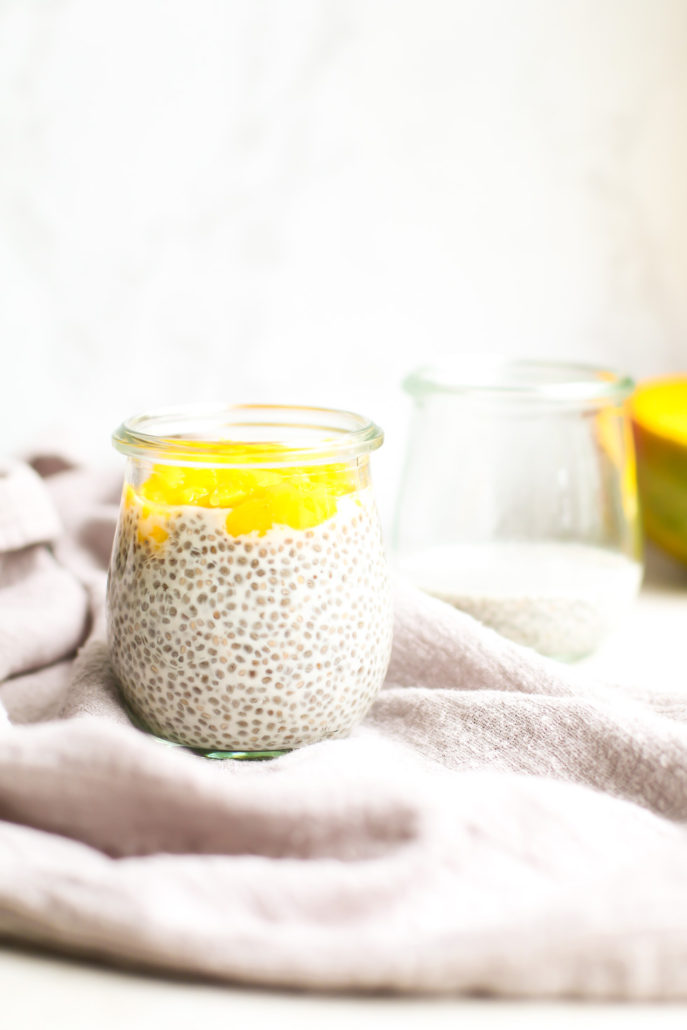 Mango Chia Seed Pudding with Collagen  in jars with a mango in back