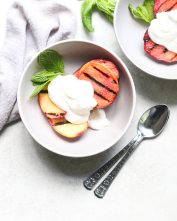 Grilled Peaches and Cream in Bowls with 2 spoons