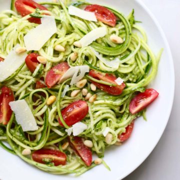 Pesto Zucchini Noodle Salad topped with pine nuts and shaved parmesan