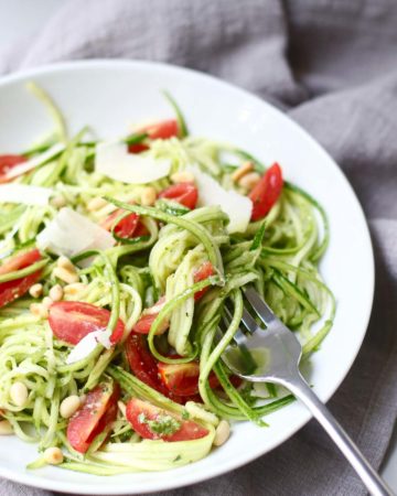 Pesto Zucchini Noodle Salad with a fork twirl