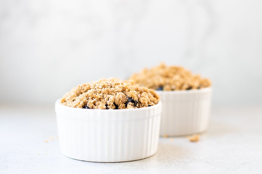 Oat Walnut Topping on blueberries in ramekins - healthy blueberry crisp