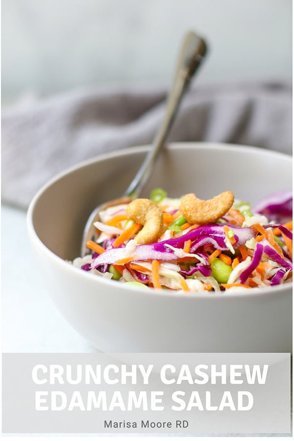 Cashew Cabbage Salad in gray bowls with two forks and a gray napkin