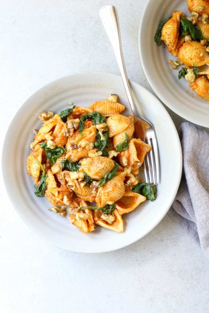 Overhead Pumpkin Pasta with Spinach in bowls with fork