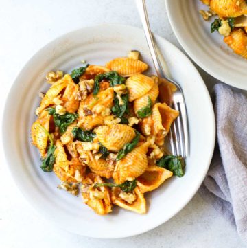 Overhead Pumpkin Pasta with Spinach in bowls with fork
