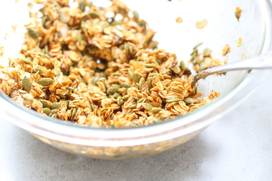 Pumpkin spice granola in a bowl with a spoon