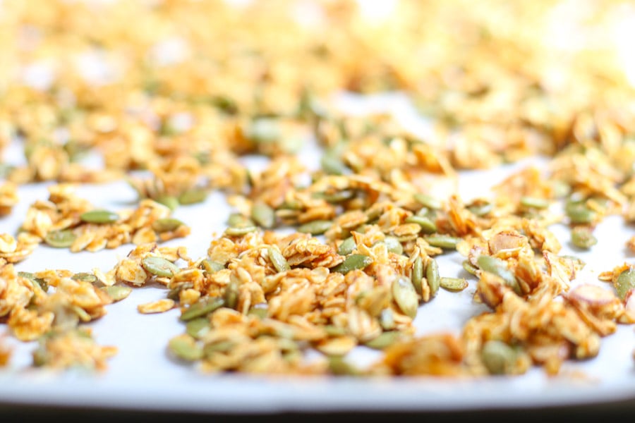 Pumpkin spice granola on parchment before baking