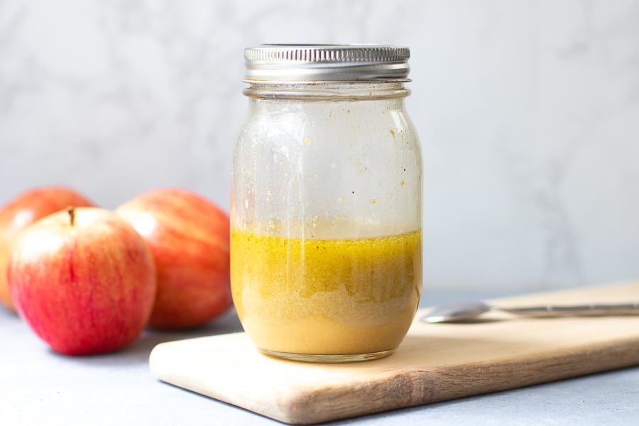 Apple Cider Vinaigrette with Apples in background