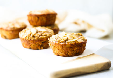Baked Oatmeal Cups on a wood board with napkin