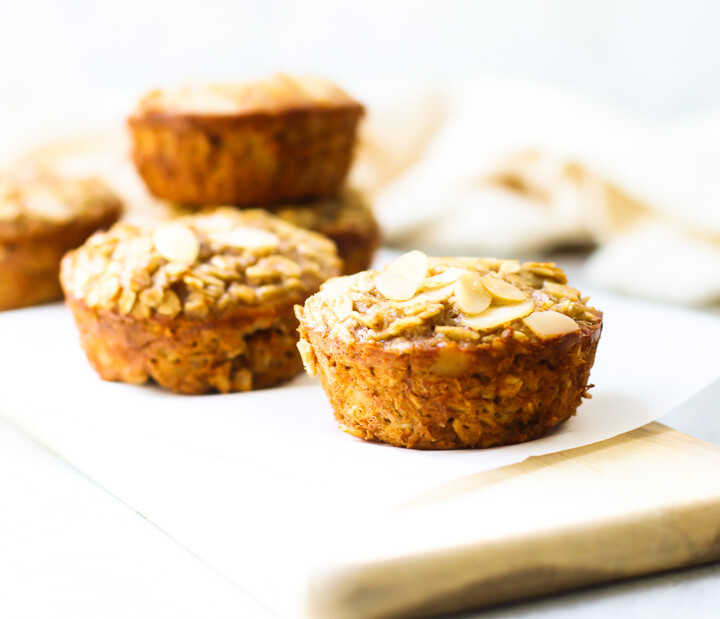 Baked Oatmeal Cups on a wood board with napkin