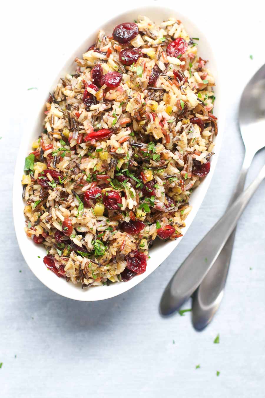 vegan wild rice stuffing in a bowl with utensils