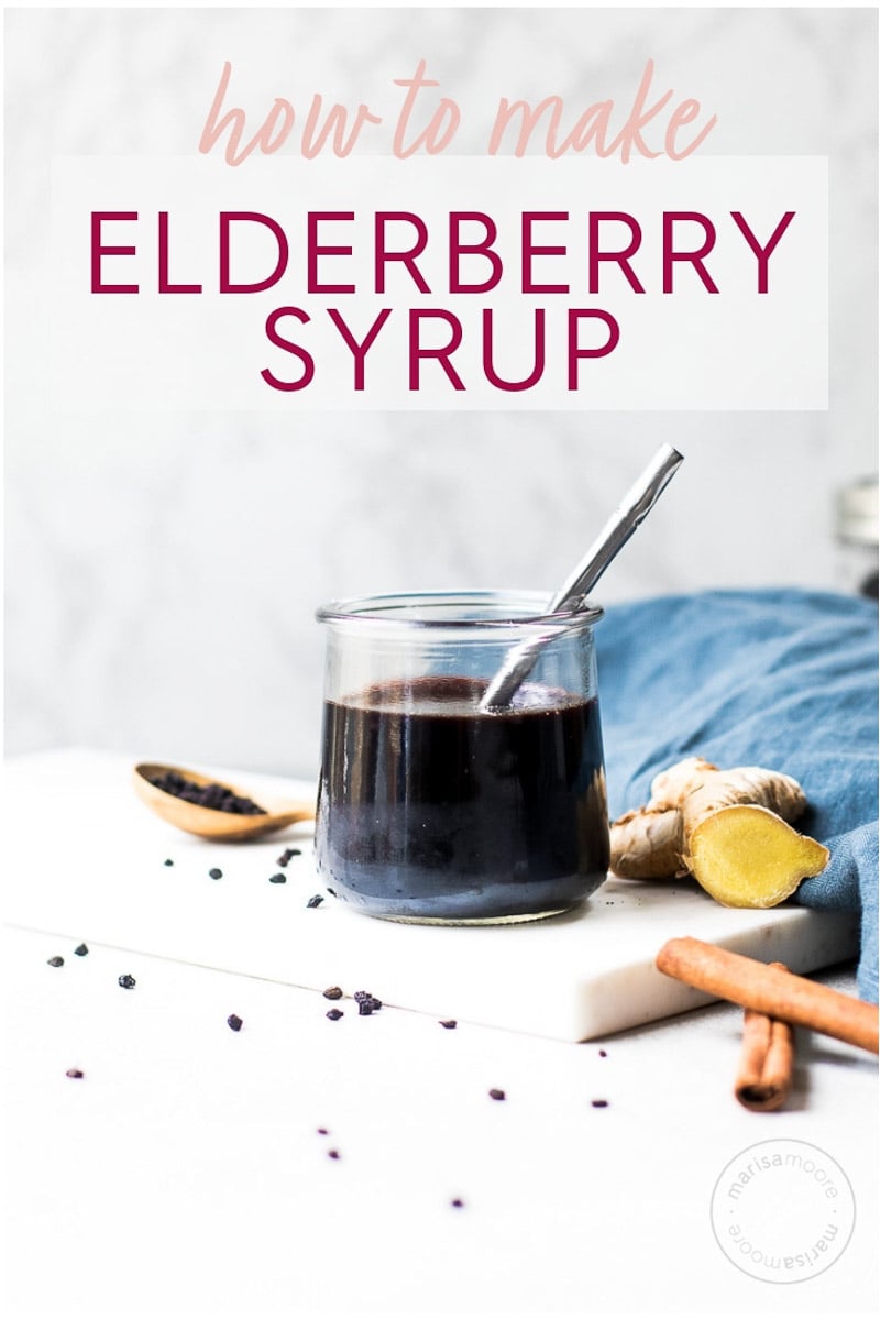 ginger elderberry syrup in a jar with ginger and cinnamon