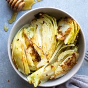 Sweet Spicy Roasted Cabbage in a bowl with honey