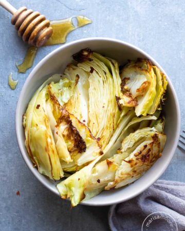 Sweet Spicy Roasted Cabbage in a bowl with honey