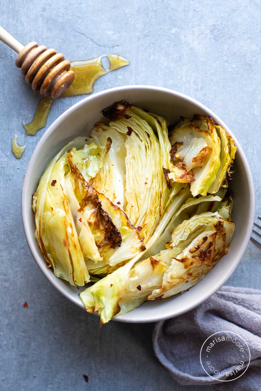 Sweet Spicy Roasted Cabbage in a bowl with honey