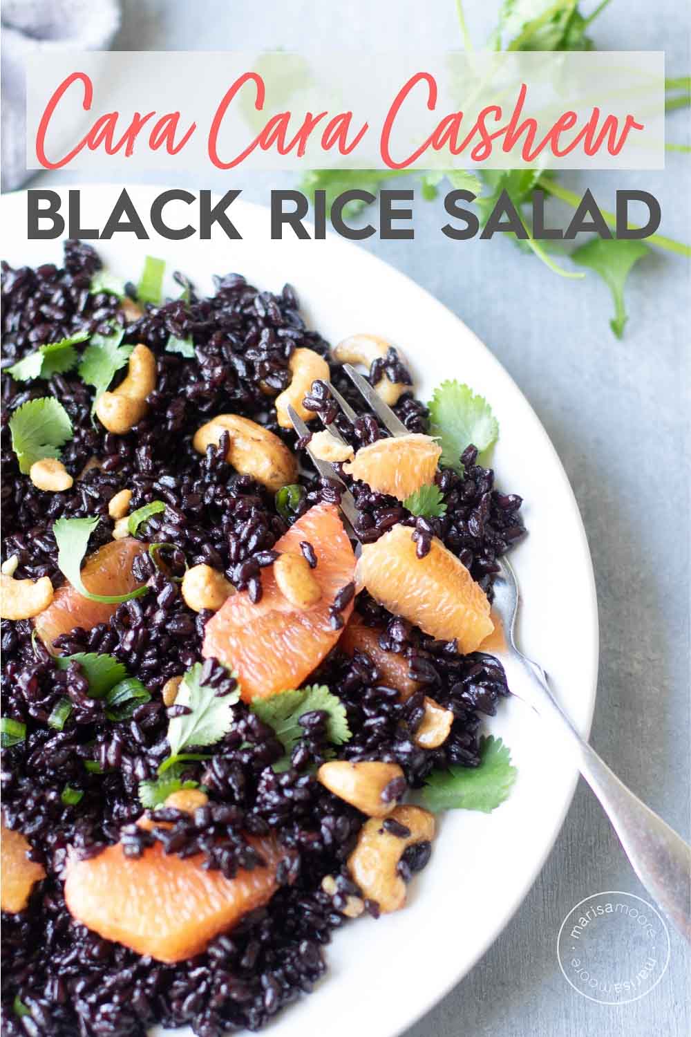 cara cara oranges and cashew black rice salad on a plate