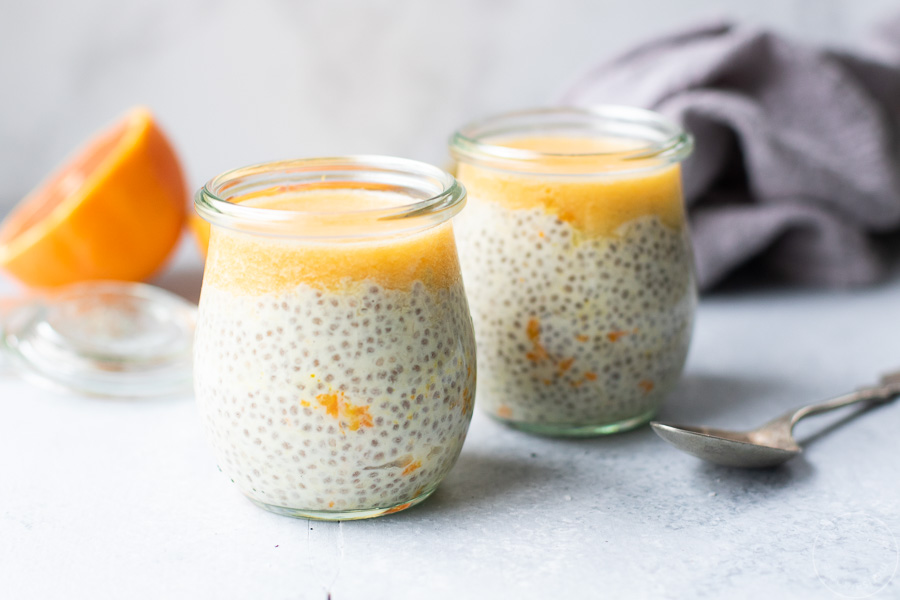 creamsicle chia pudding in jars with spoon and napkin