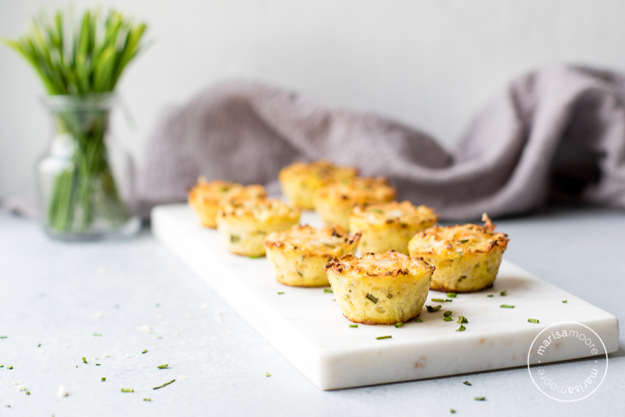 Cheddar Chive Cauliflower Bites on marble with logo