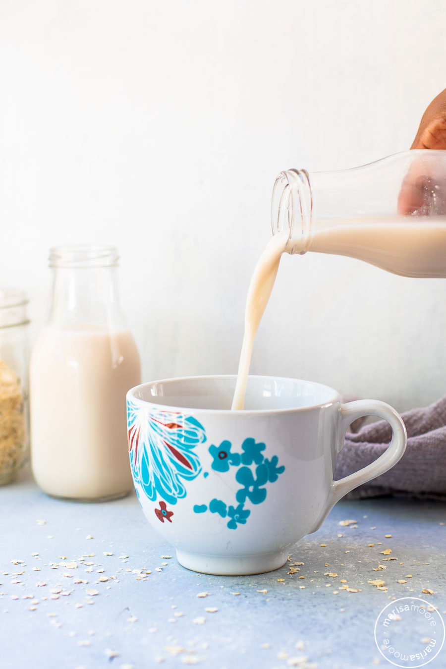 Pouring oat milk into a cup