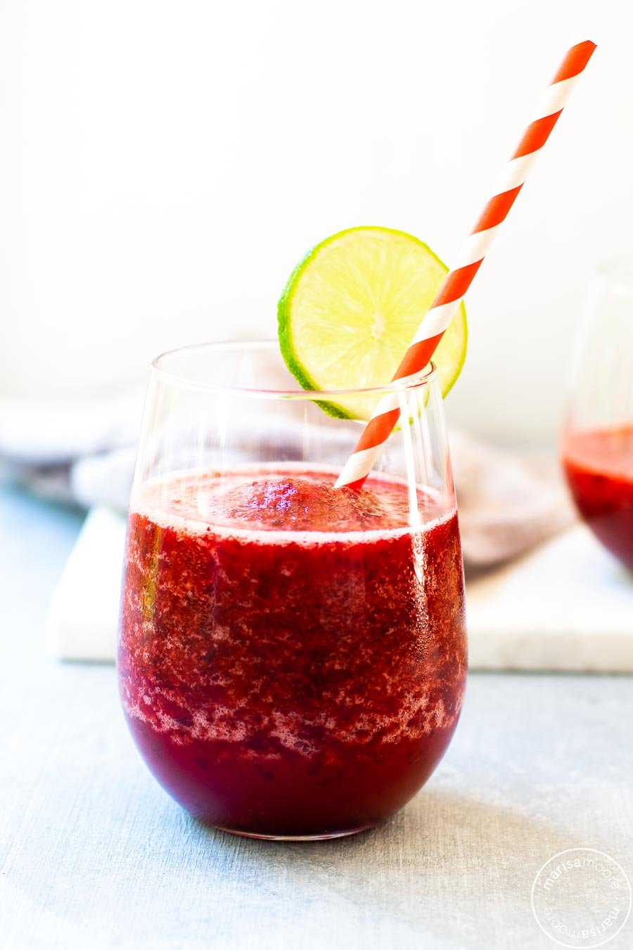 Cherry Lime Slush with straw and slice of lime