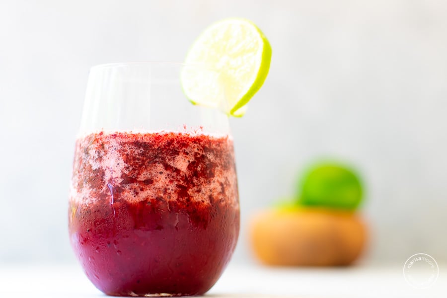 Cherry Lime Slush in a glass with slice of lime