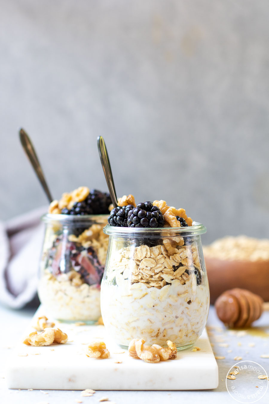 Blackberry Walnut Overnight Oats in jars with oats background