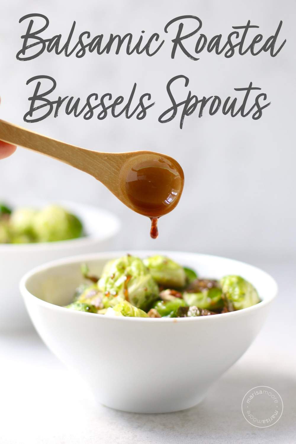 Roasted brussels sprouts in bowl with balsamic glaze on a spoon