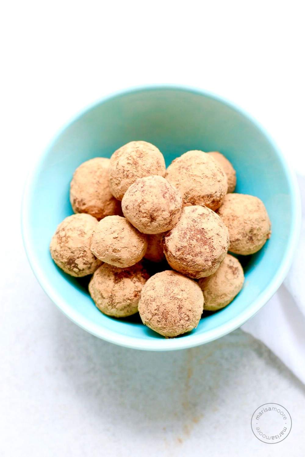 cocoa almond truffles in a blue bowl