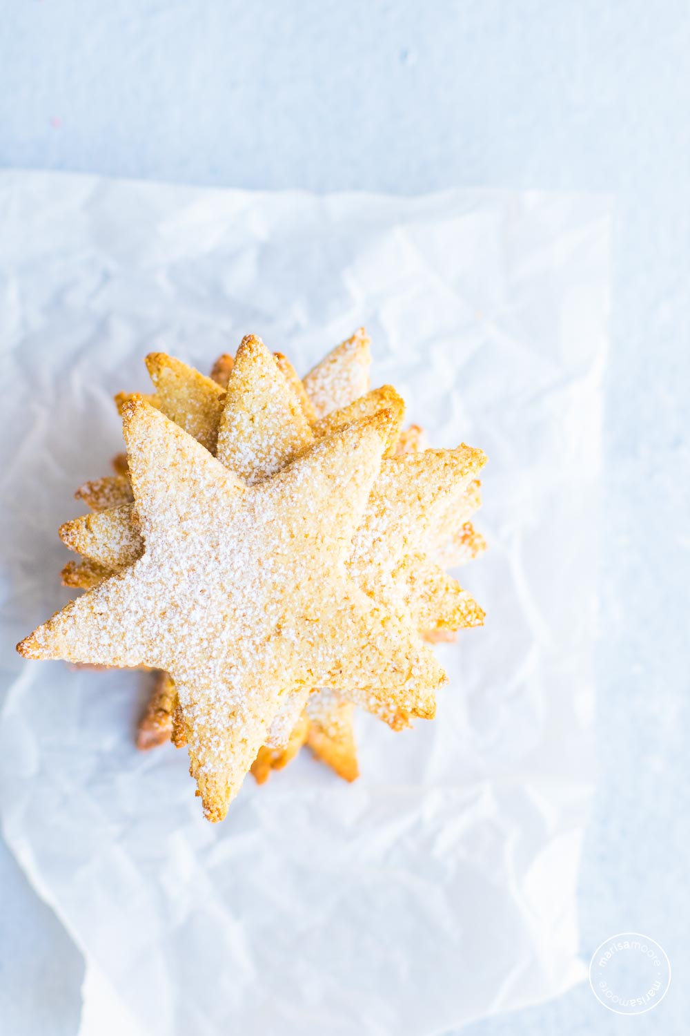 star cookies stacked on parchment