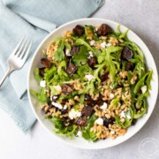 California Fig Farro Salad in a bowl with a fork and napkin