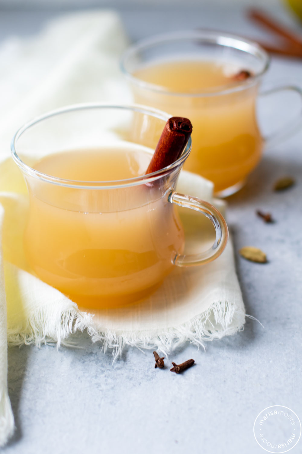 Pear Cider in clear mugs with cinnamon sticks