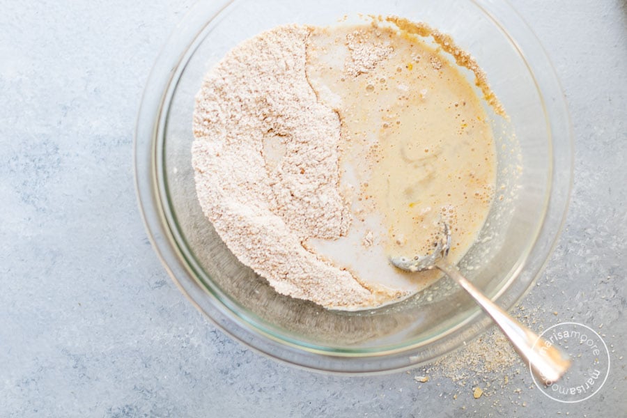 Making Oat Flour Pancakes Adding Liquid in a bowl