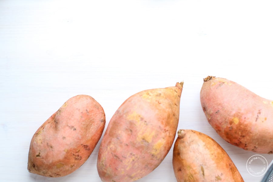 Whole sweet potatoes on a white background