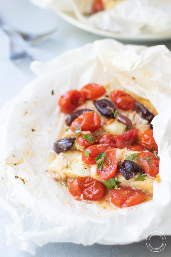 fish in parchment with tomatoes and olives on top