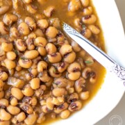 close up of a black-eyed peas in a white bowl