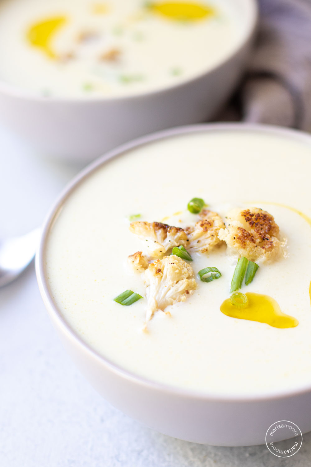 cauliflower soup in two gray bowls