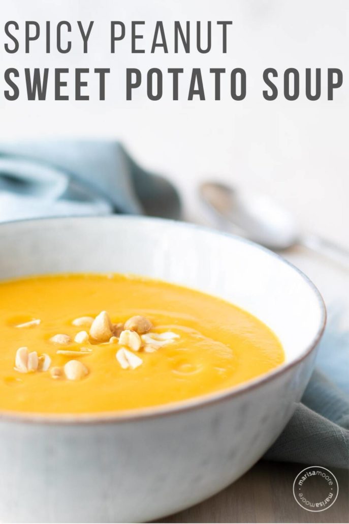 sweet potato soup in a grey bowl with blue napkin