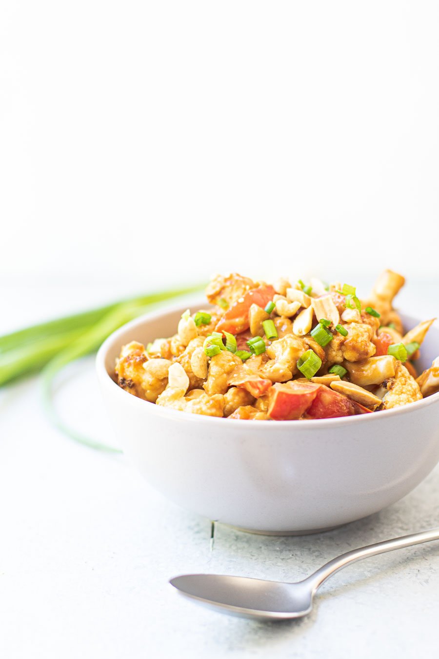 cauliflower stir-fry in a bowl with a spoon in front