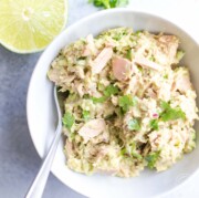 avocado lime tuna salad in white bowl with a fork