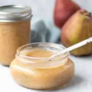 pear sauce in a mason jar with pears in background