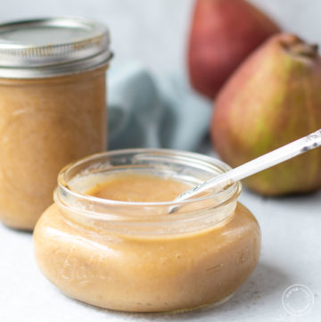 pear sauce in a mason jar with pears in background