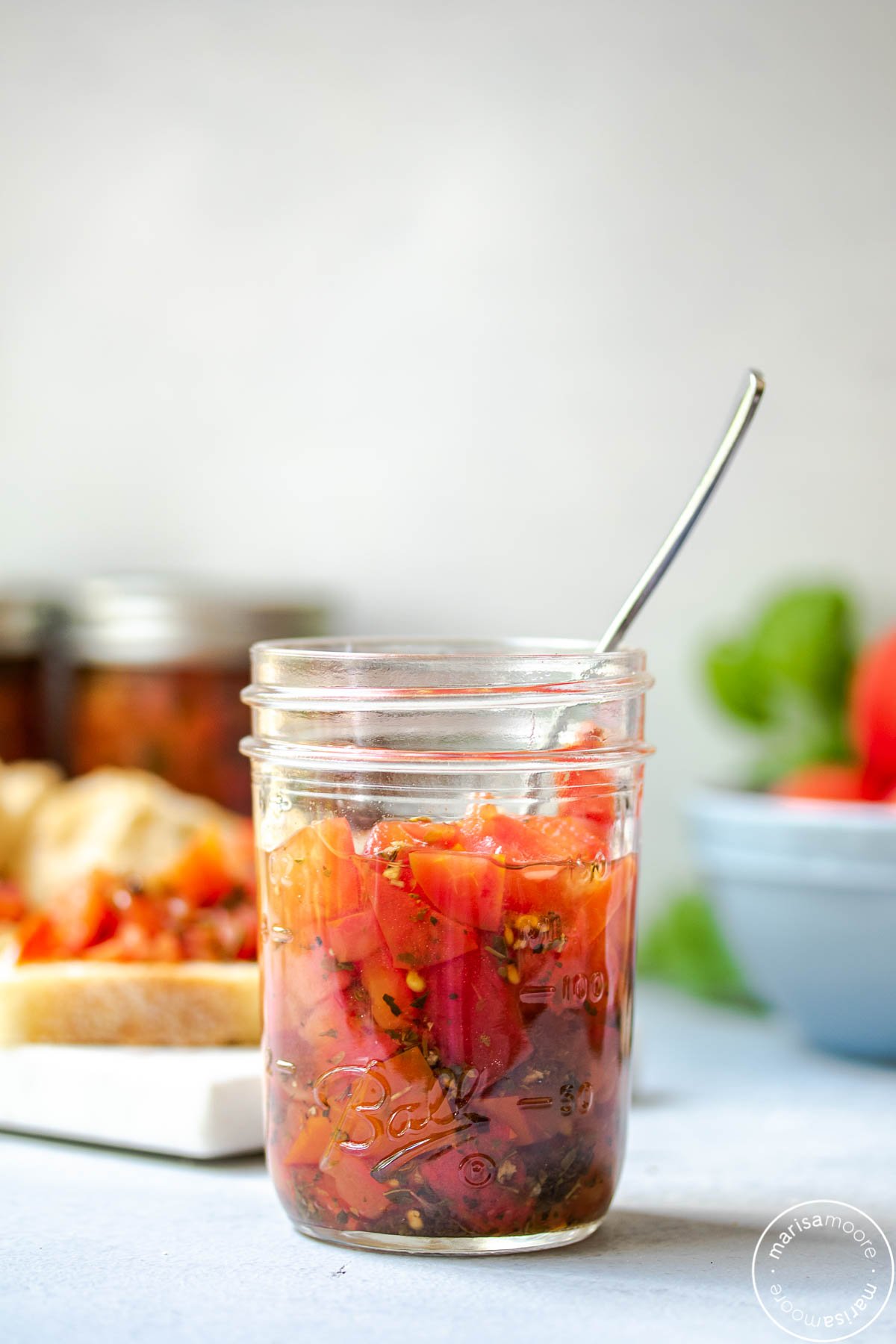 half pint jar of bruschetta with crostinis in the background